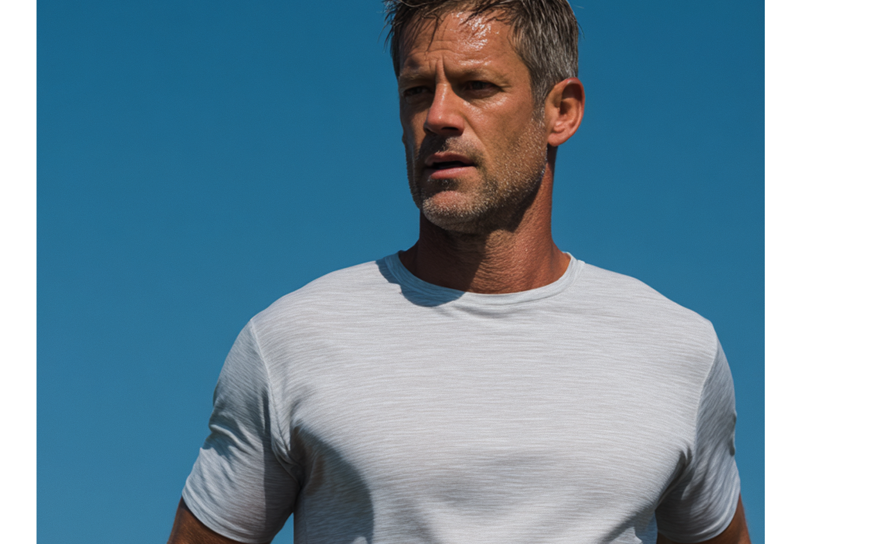 Athletic man in profile against a clear blue sky, ready for an executive assessment
