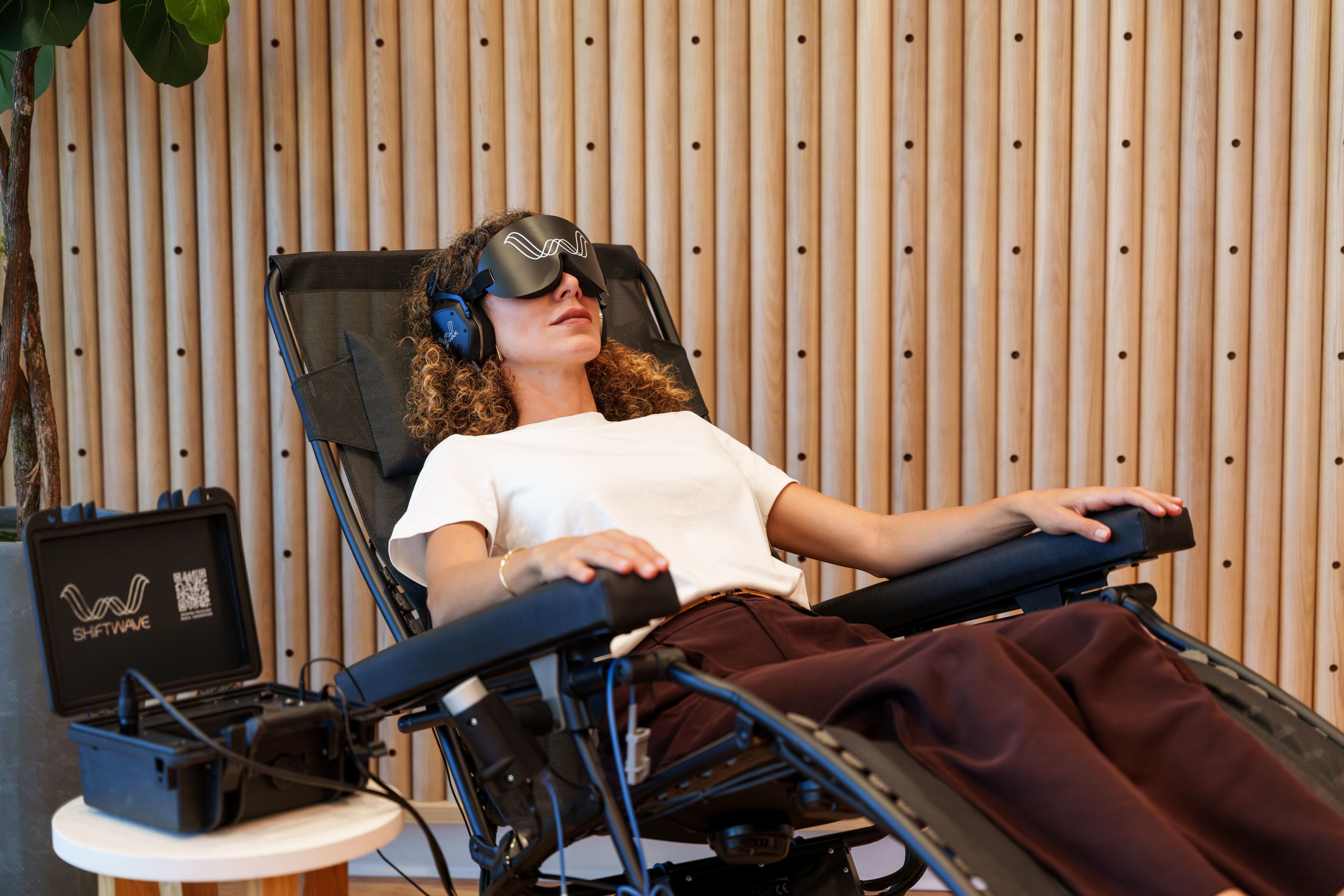 A member reclined in the Shiftwave therapy chair