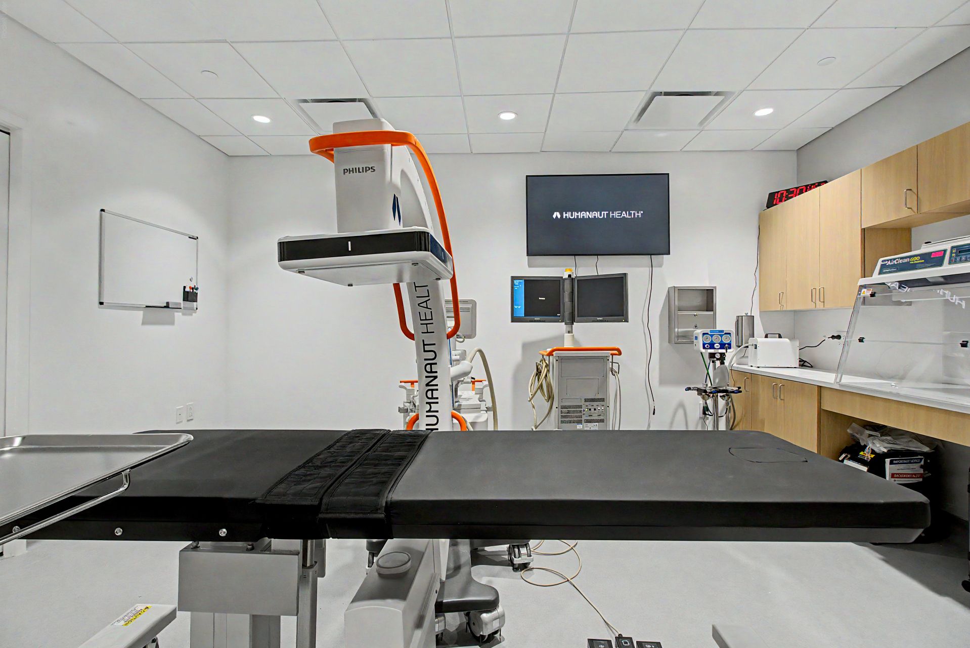 Procedure room with Philips imaging equipment and a Humanaut-branded treatment table