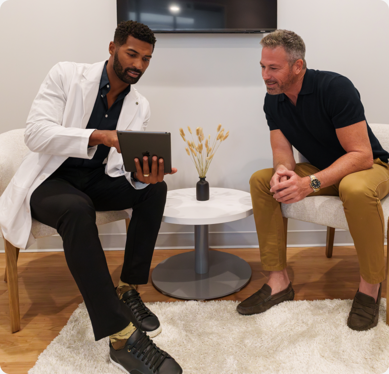 Clinician reviewing test results on a tablet with a male patient