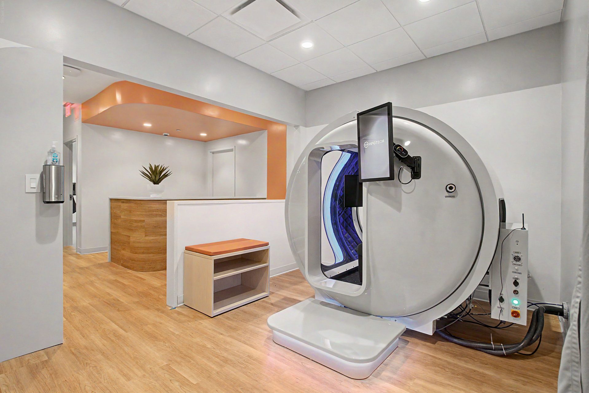 Hyperbaric oxygen therapy chamber in a warm sunlit treatment suite