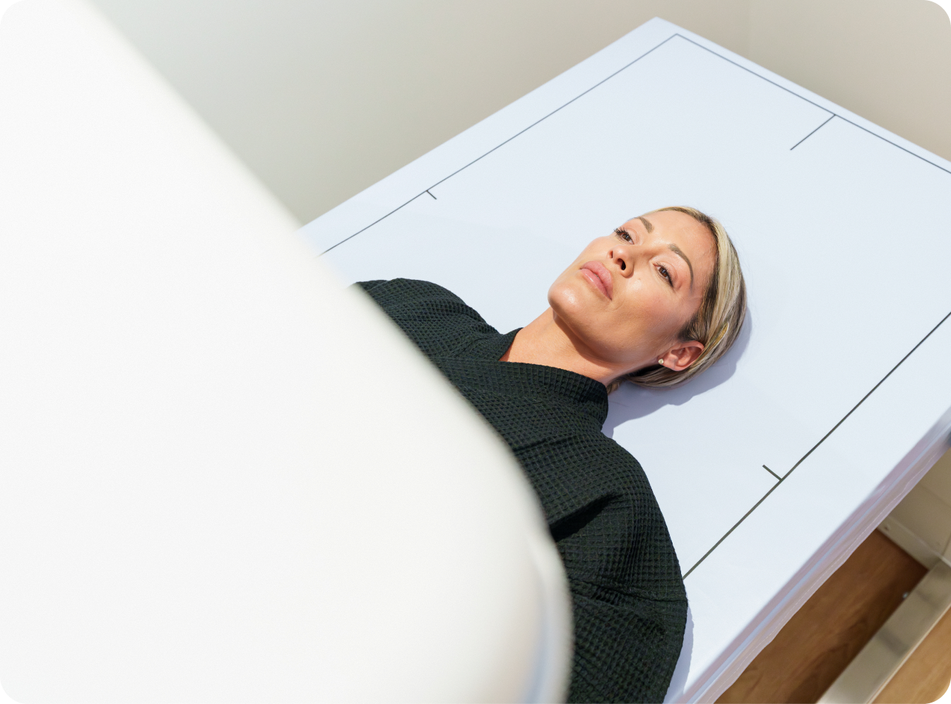 Member resting on a treatment bed during a baseline diagnostic visit