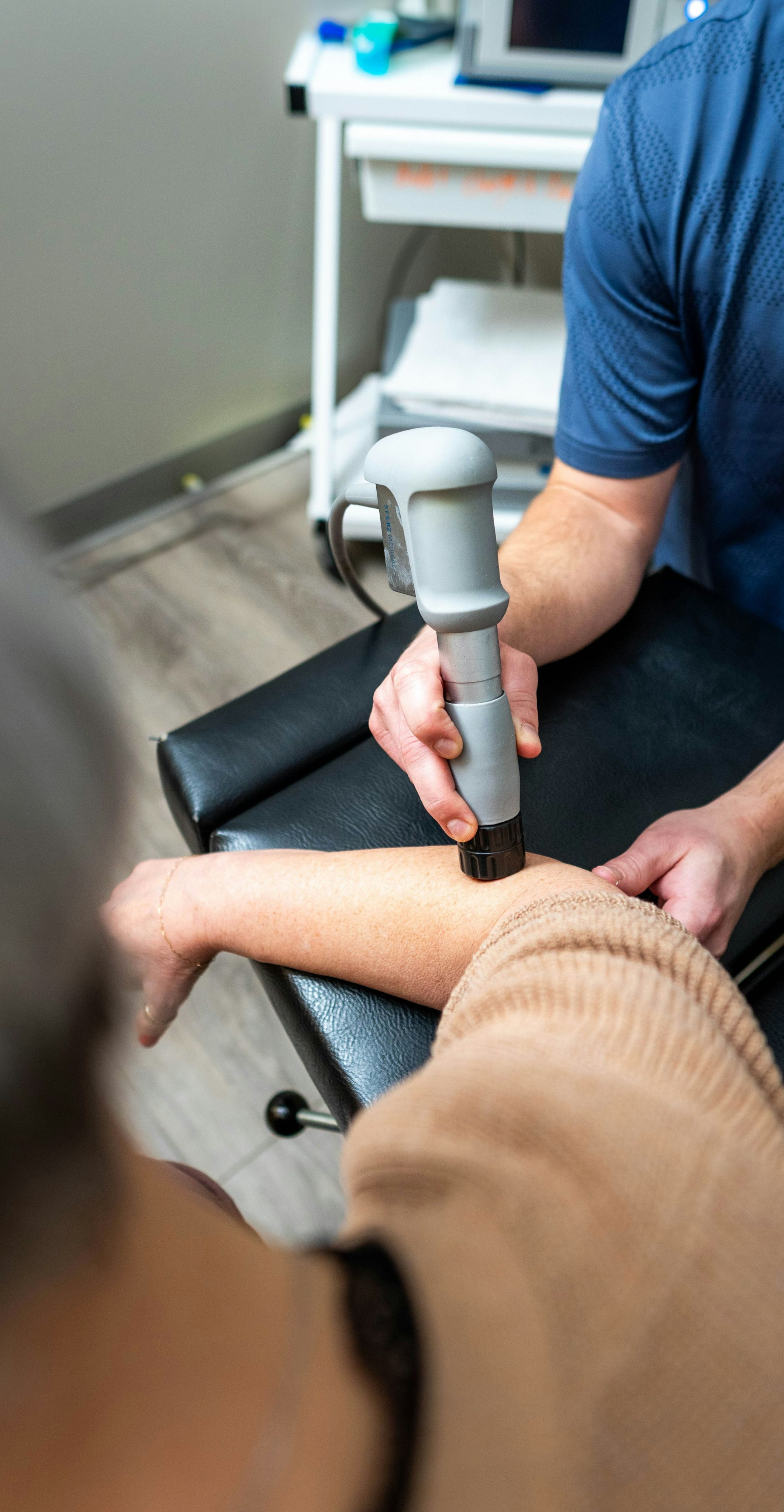 Shockwave therapy session behind the science overlay