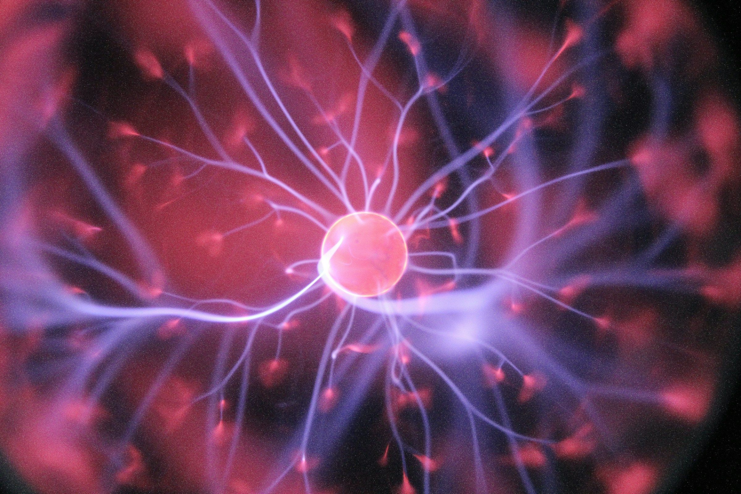 Red plasma sphere with branching electric filaments